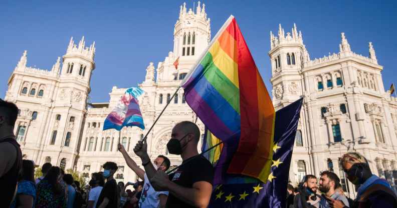 A protester waves a Pride flag in Madrid, Spain