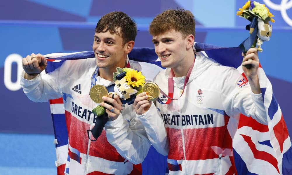 Tom Daley Matthew Lee pose with their gold medals at the Tokyo 2020 Olympic games