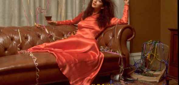 Musician Kate Bush posed on a sofa covered with party streamers in promotion of her one-off Christmas television special. (TV Times via Getty)