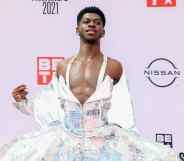 Lil Nas X poses for a photograph at the BET Awards in a flowing dress