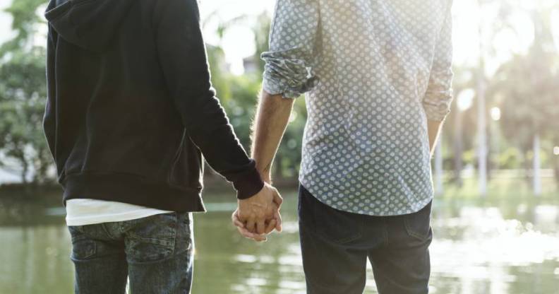 same-sex couple holding hands homophobic abuse