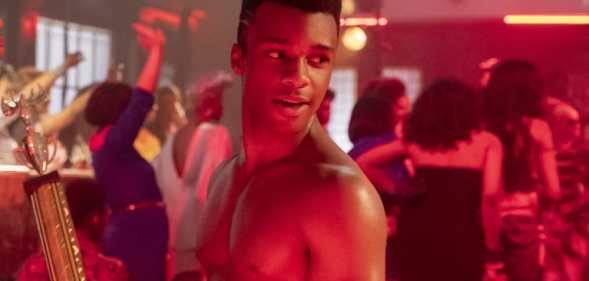 Dyllón Burnside as Ricky in Pose, topless, holding a trophy