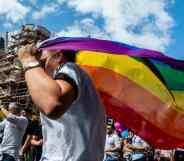 A person holds an LGBT+ Pride flag during the Antwerp Pride event in 2019 the pride march is used to stand up to homophobia and transphobia as well as celebrate the LGBT+ community in Belgium