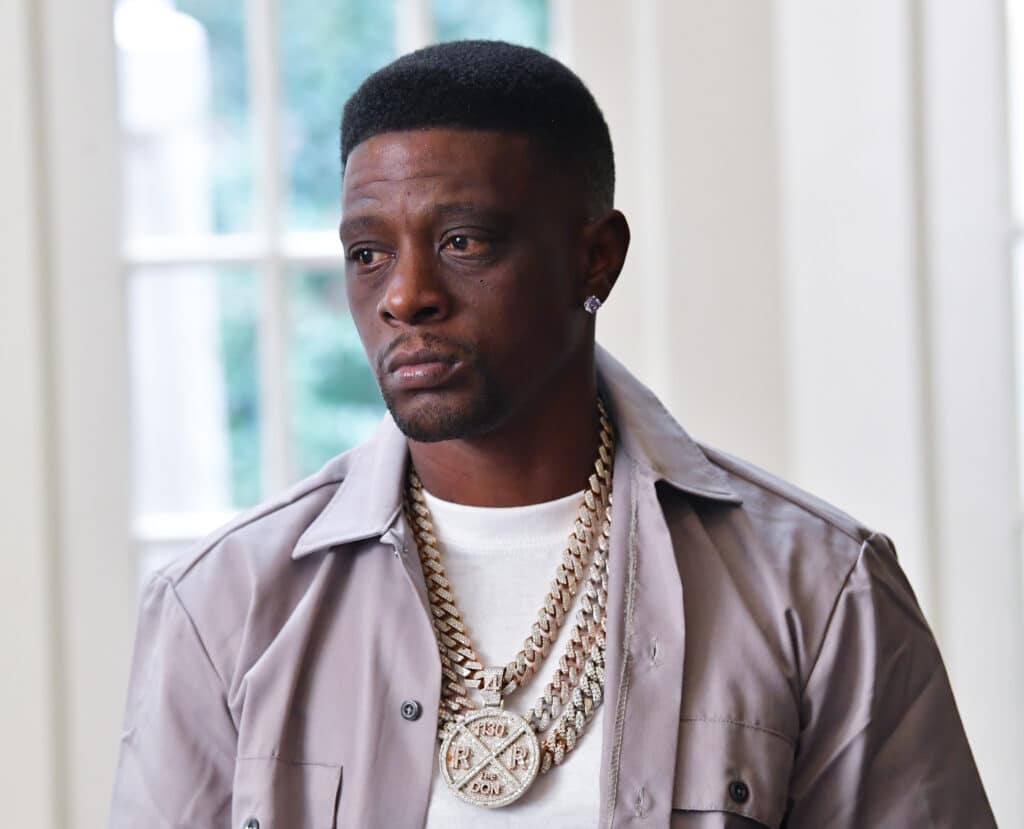 Boosie Badazz in a grey shirt and white t-shirt looking to the right