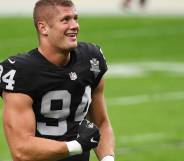 Carl Nassib openly gay NFL player flexes while smiling