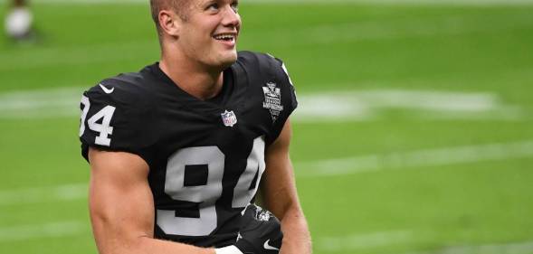 Carl Nassib openly gay NFL player flexes while smiling