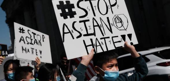 People participate in a protest to demand an end to anti-Asian violence in the US