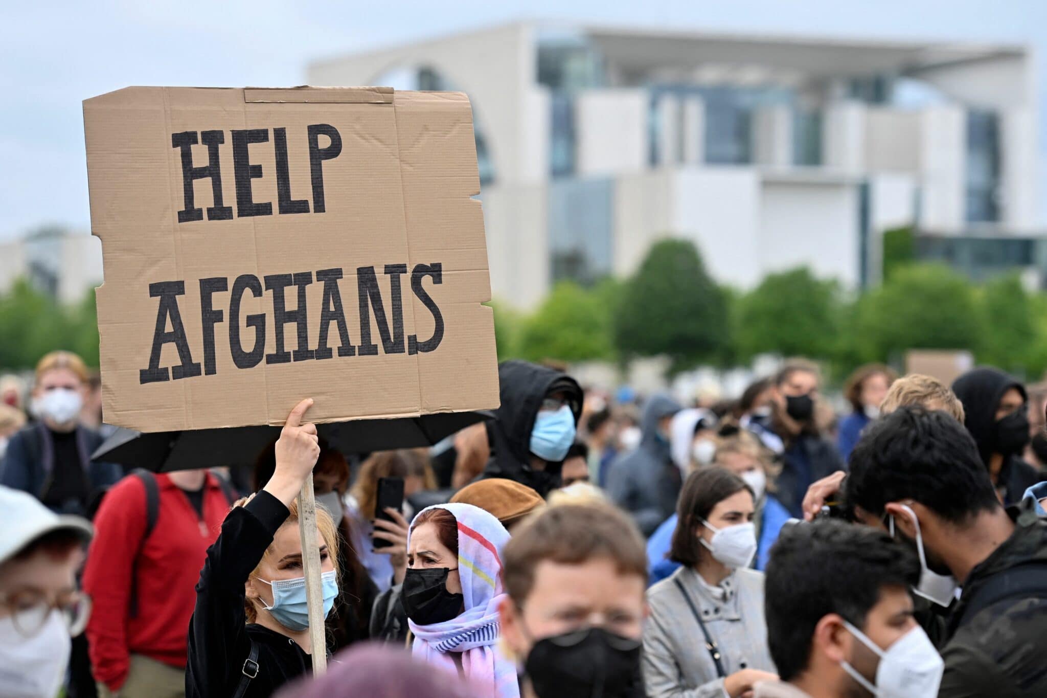 A participant holds up a placard reading 'Help Afghans' during a demonstration