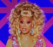 RuPaul in full drag, wearing a pink dress and blonde wig