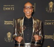 RuPaul on the red carpet at the creative arts Emmys holding his awards