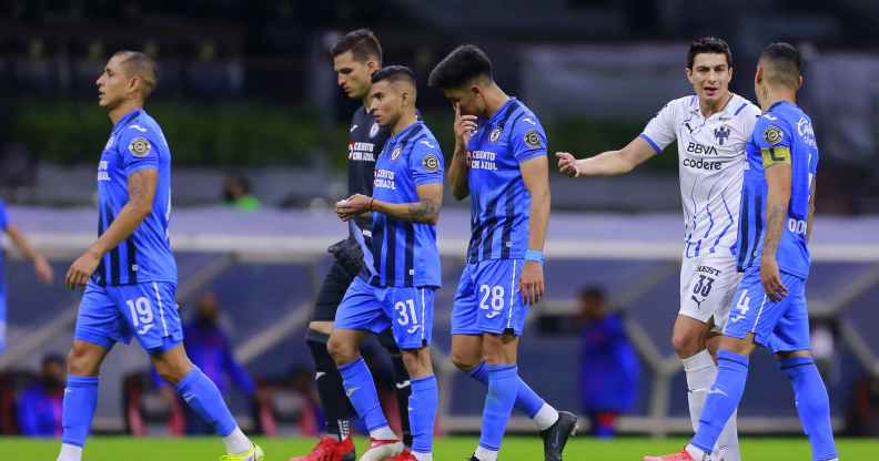 Football players leave the field as the game is suspended