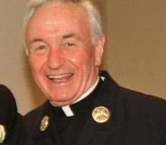 Fire Department chaplain Mychal Judge smiles for a photograph 28 July 2001, Judge was killed in the 9/11 attack later that year