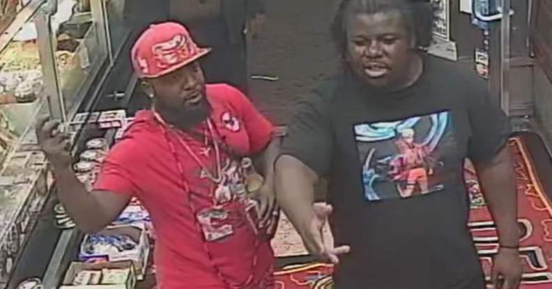 Two men, one wearing red and the other black, stand in a shop