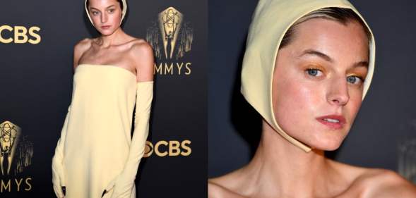 Emma Corrin at the Emmys wearing a yellow Miu Miu sheath dress, matching bonnet and sharp claws poking through long gloves