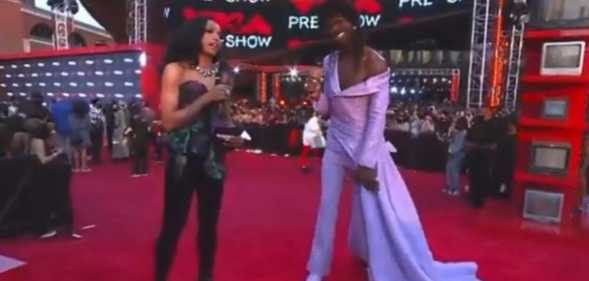 Lil Nas X in a lilac gown and MTV's red carpet host Jamila Mustafa