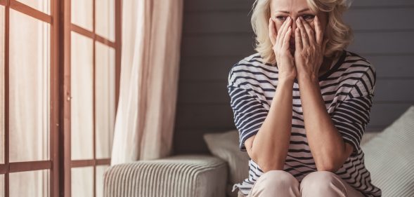 Sad woman sitting on a sofa