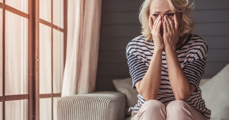 Sad woman sitting on a sofa