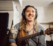 Eric Bolton poses with a guitar