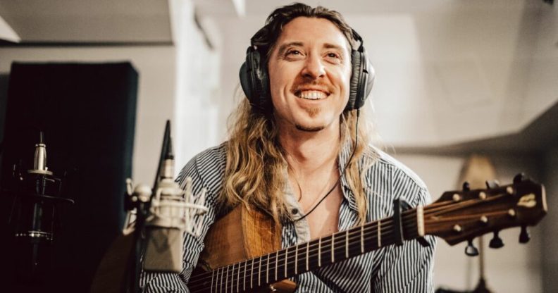 Eric Bolton poses with a guitar