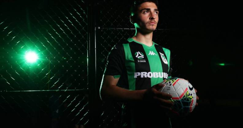 a picture of josh cavallo in a green uniform holding a white football