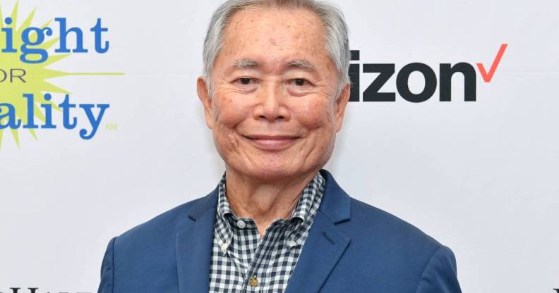 George Takei attends PFLAG conference in blue suit jacket and patterned shirt