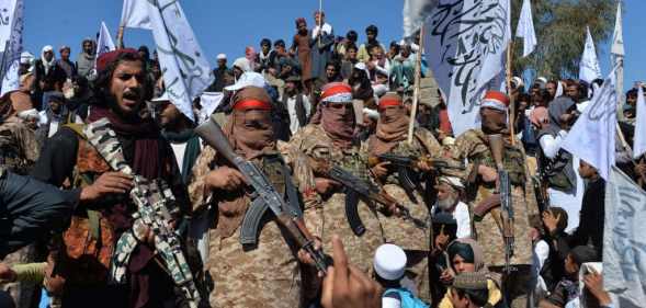 Afghan Taliban militants and villagers attend a gathering as they celebrate the peace deal and their victory in the Afghan conflict on US in Afghanistan, in Alingar district of Laghman Province on March 2, 2020.