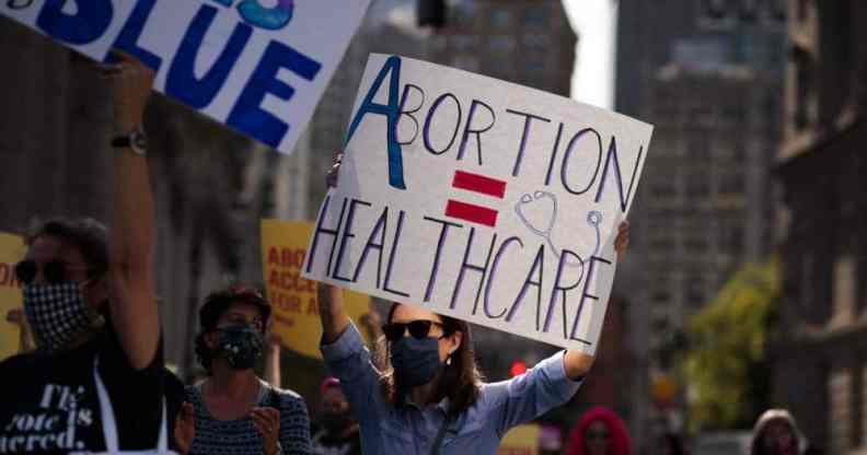 Protestors hold up signs at the Women's March and Rally for Abortion Justice in New York