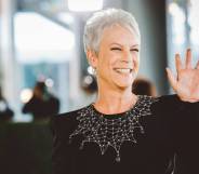 Jamie Lee Curtis waves at the crowds in a black dress with a collar designed to look like spider web