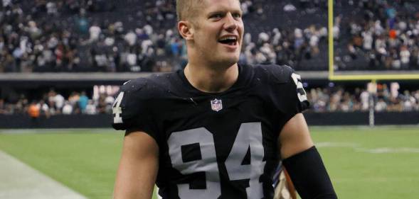 Carl Nassib of the Las Vegas Raiders celebrates as he walks off the field after the team's victory over the Miami Dolphins