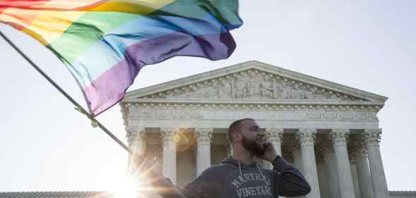 Same-sex marriage supporter Vin Testa, of Washington DC, waves a rainbow pride flag near the Supreme Court