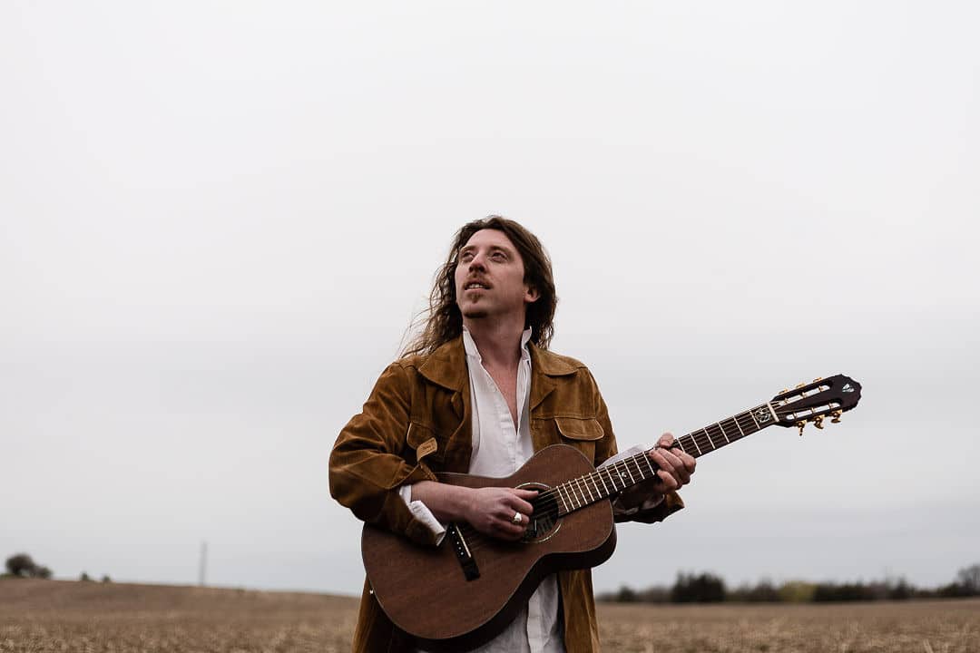 Eric Bolton poses with a guitar