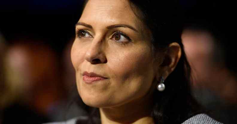 Priti Patel smirking