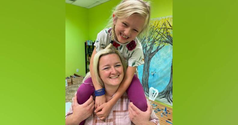 Sunny Bryant smiles and sits on the shoulders of her mum, Bekah