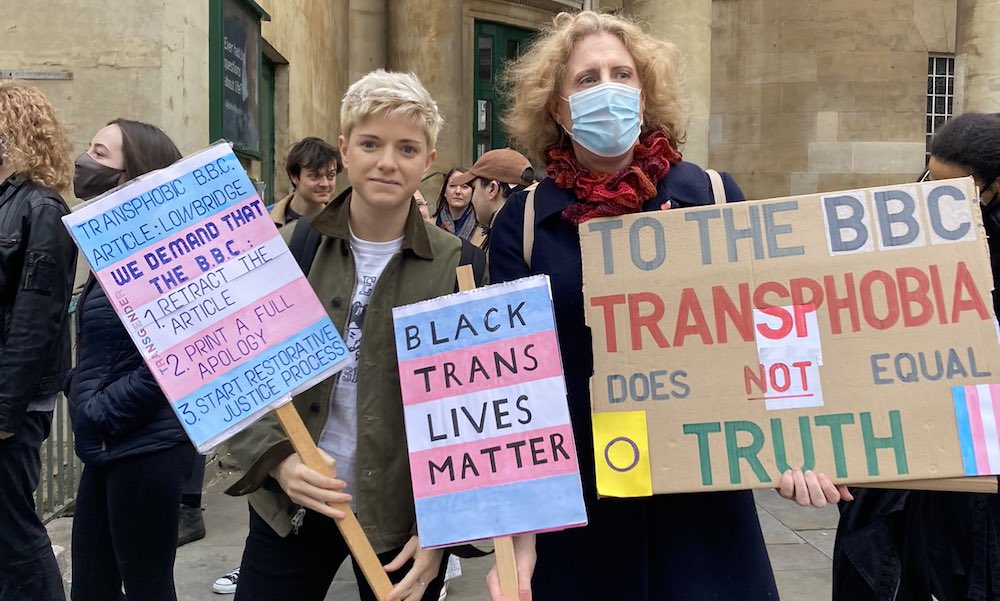 Mae Martin holds placards at the protest outside Broadcasting House