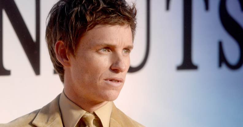 Eddie Redmayne looks to the side on the red carpet