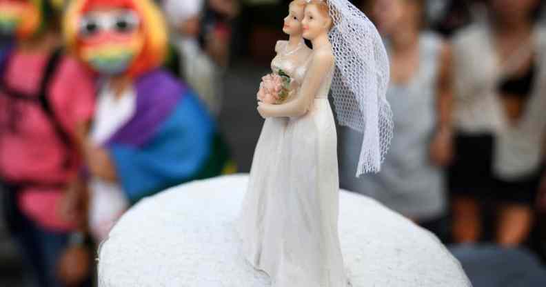 Two female cake-toppers on wedding cake