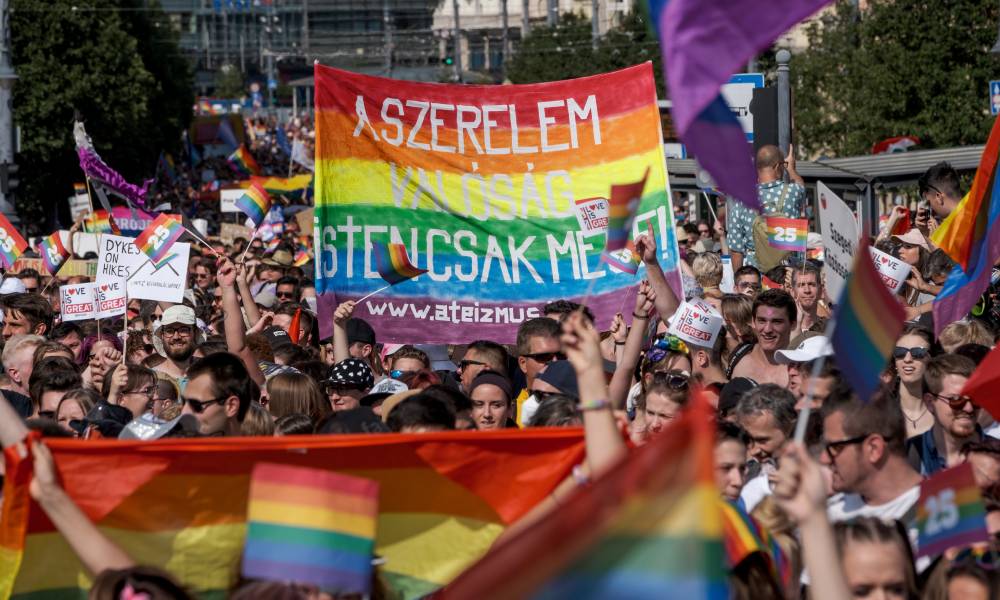 Demonstrators mark with LGBT+ Pride flags during a Pride parade in Budapest, Hungary