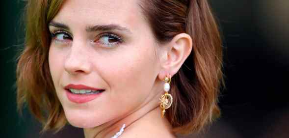 Emma Watson turns to the side and smiles