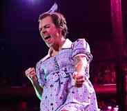 Harry Styles is dressed as Dorothy from the Wizard of Oz during a concert