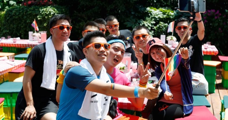 A group poses for photos at Shanghai Pride