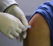 A needle is inserted into a person's arm