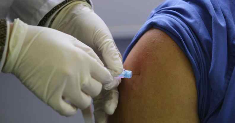 A needle is inserted into a person's arm