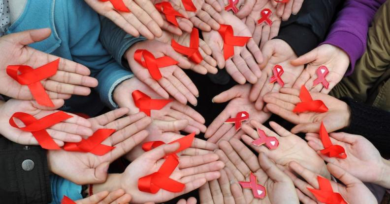 University students in China display red ribbons to mark World AIDS day