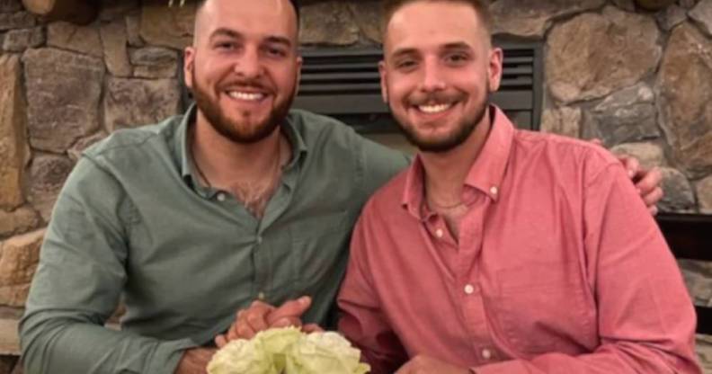 Husbands Reid Alexander and Rafael Díaz pose for a photo and hold hands