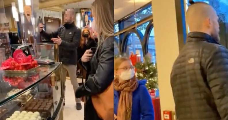 A man points his phone at a café worker behind a counter