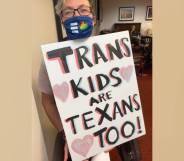 Hillary Moore-Embry holds up a sign that reads "Trans Kids are Texans Too!" in support of the trans community in Texas