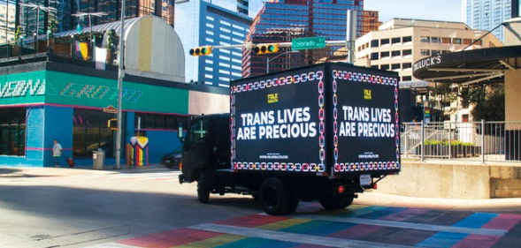 Billboard reading "trans lives are precious" in Texas