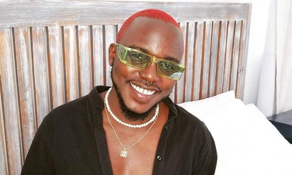 Kenyan singer Chimano smiling with his dog