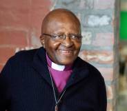 Archbishop Emeritus and Nobel Laureate Desmond Tutu smiles at the camera while attending an exhibition in Cape Town in 2019