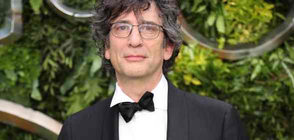 Neil Gaiman attends the global premiere of "Good Omens" in a black and white suit with a black bow tie